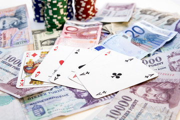 Poker hands - cards have focus with poker chips and money