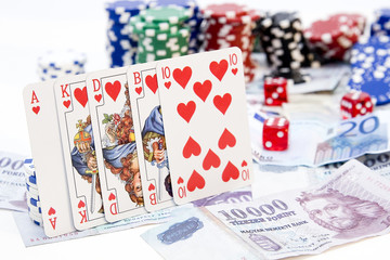 Poker hands - cards have focus with poker chips and money