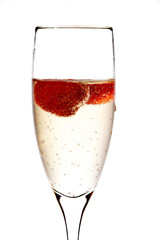 Glass of champagne with strawberry inside