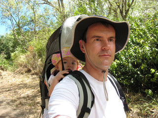 Dad hiking with baby daugther
