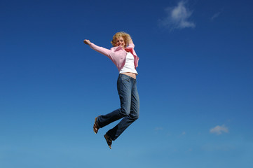 Fototapeta premium Jumping woman on a sunny day