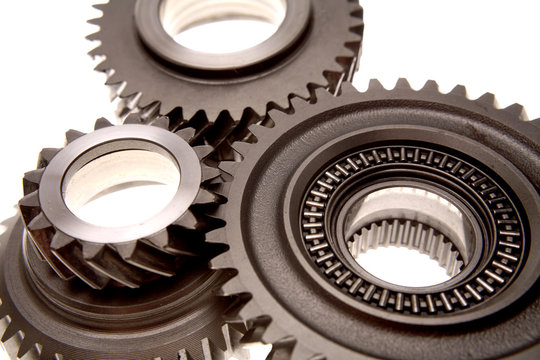 Closeup Of Three Gears Over White