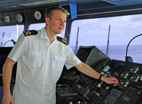 Navigation officer works with a navigation chart