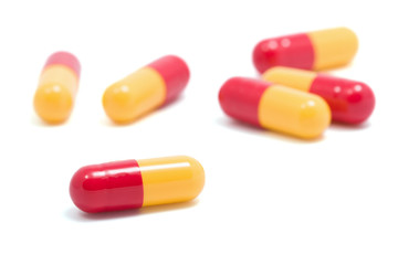 red and yellow capsule pills isolated