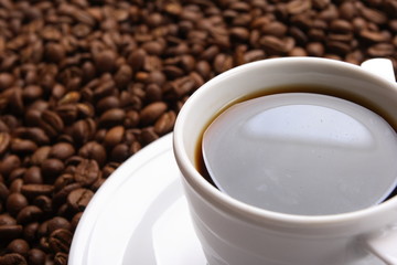 Cup with coffee, costing on coffee grain