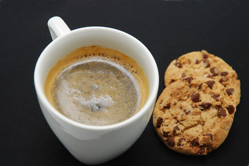 coffee and biscuits on black background