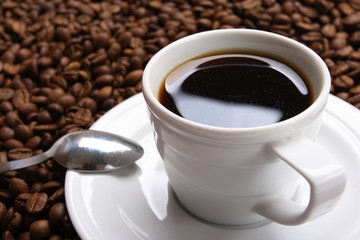 Cup with coffee, costing on coffee grain