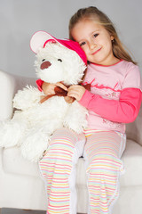 Nice young girl in pink on light background