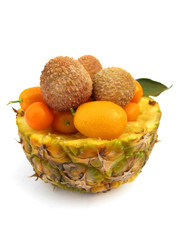 Tropical fruit kumquat and lychee in pineapple pot