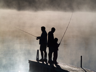Early morning fishing in autumn on a lake.