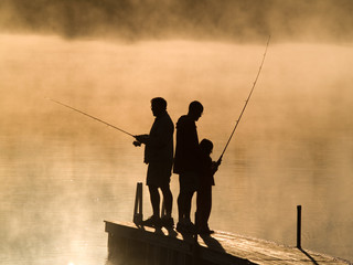 Early morning fishing in autumn on a lake.