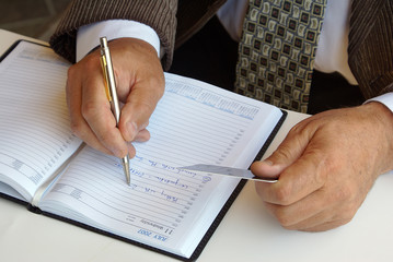 Man filling his agenda