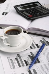 Cup of fragrant coffee on a morning paper business news