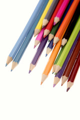 Colored pencils over white background