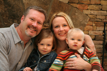 Family in front of fireplace
