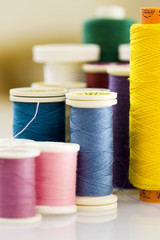 close up of different colors of thread.