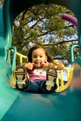 Toddler Girl on Playground Slide