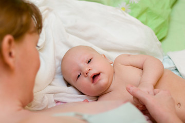 Mother and baby relaxing in the bed