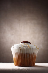 marple and pecan sponge cup cake on brown rustic background