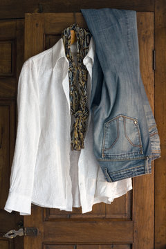 white cotton blouse, scarfe and jeans on antique cabinet