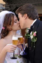 Toasting and kissing newlywed couple
