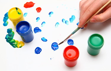 Hand painting and many paint jars with gouache