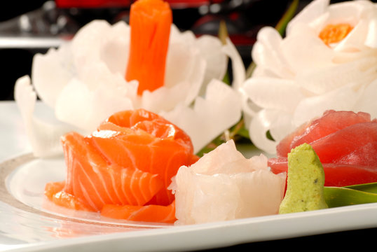 Fresh salmon and tuna sashimi with dicon radish flowers