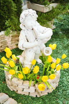 boy statue with tulips