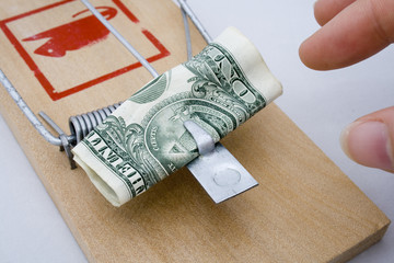 Money Trap - US Dollar being taken from a rat trap