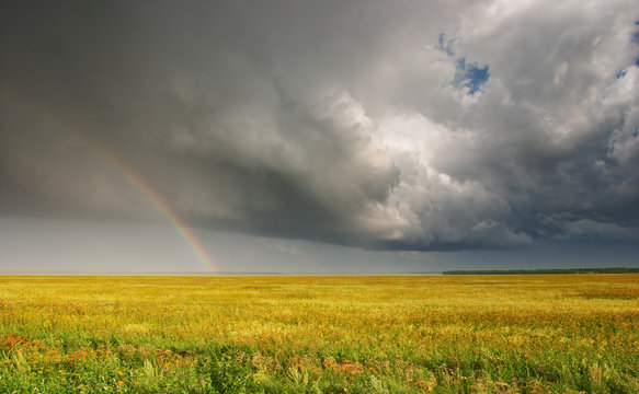 Landscape with storm clouds and rainbow