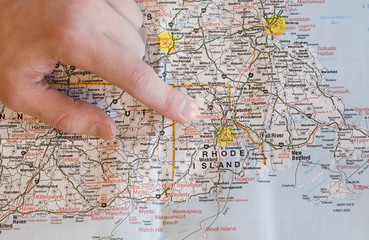 Hand pointing to map finding directions