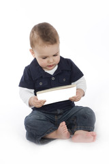 cute little boy reading a book