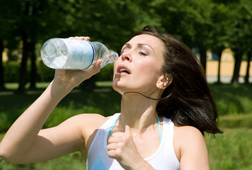Runner drinking water outdoors
