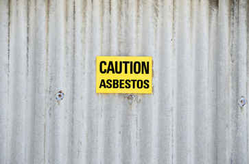 Sign with text CAUTION ASBESTOS