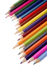 Colored pencils over white background