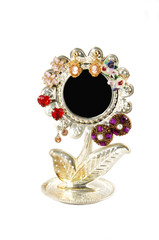 An antique mirror whit earrings.