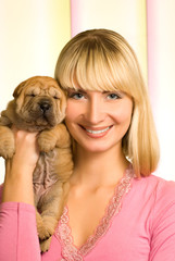 Beautiful girl with sharpei puppy