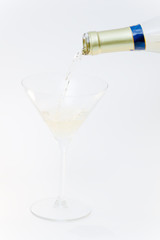 Filling one glass with wine by holding in hand bottle