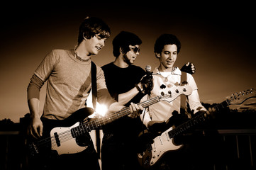 Portrait of young rock band performing - monochrome