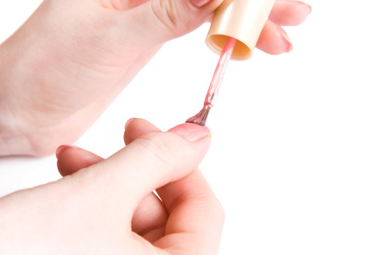 Young woman paint her nails close-up