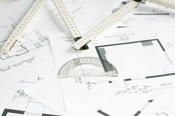 Square set and measurement tool over blueprints