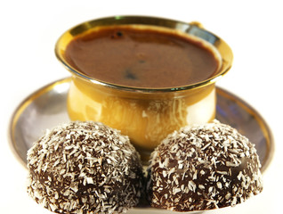 Cup of coffee and sweet with a coco