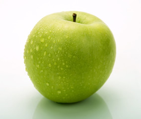 A green apple with water drops