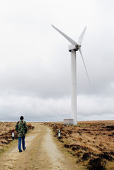 Person walking towards wind turbine