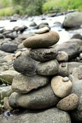 Fototapeta na wymiar Stack of rocks next to stream