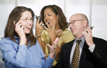 Three Businesspeople on Cell Phones