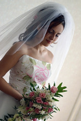 Bride in white wedding dress with veil