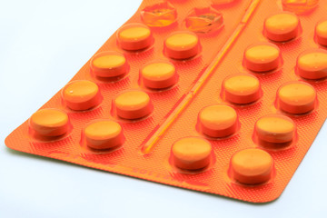 Obraz na płótnie Canvas Orange pills in orange package
