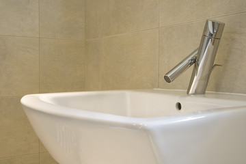 Closeup of contemporary hand-basin and tap