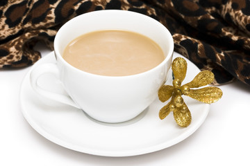 white cup of coffee with golden flower